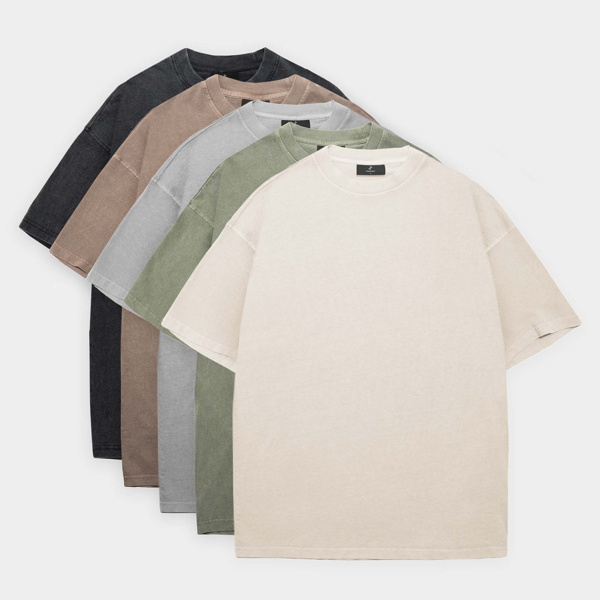 Set of five folded t-shirts in different colors on a white background