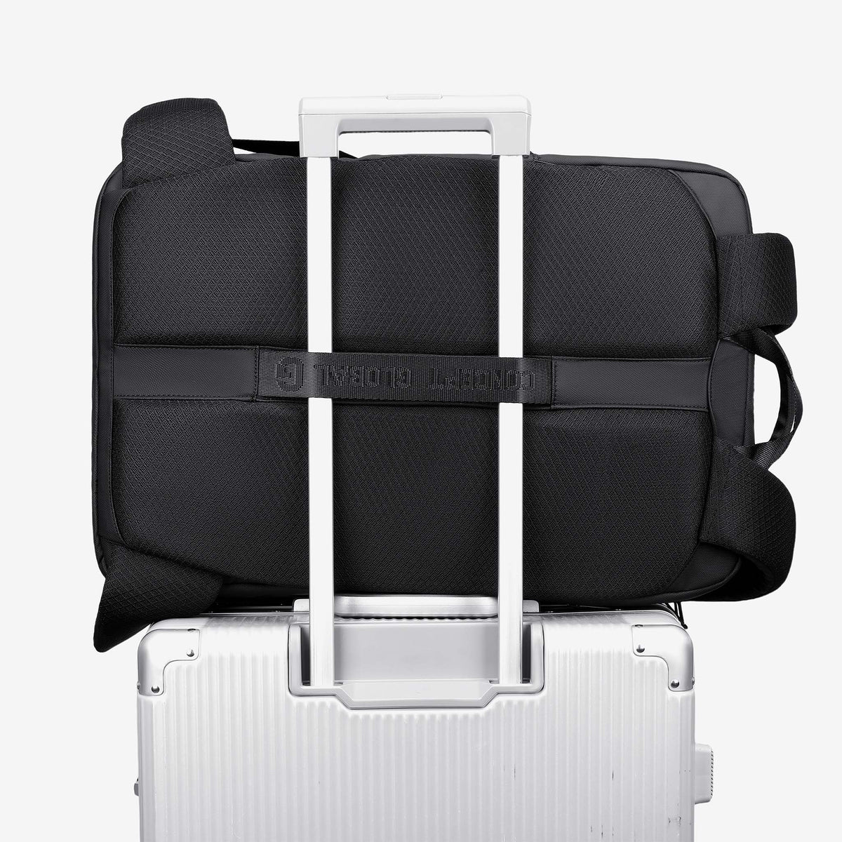 Travel Backpack luggage strap slid over a suitcase handle